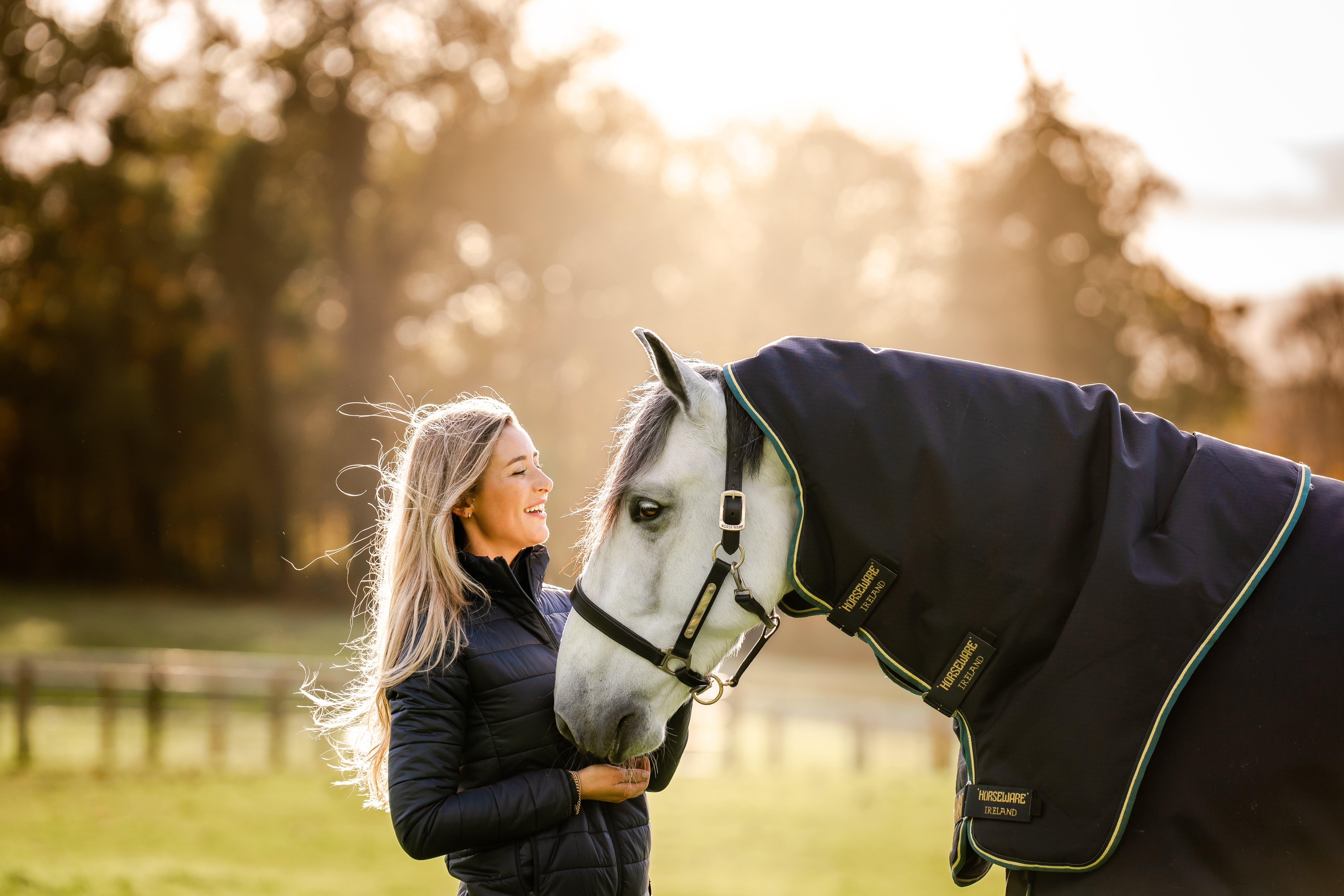 A woman standing next to a horse