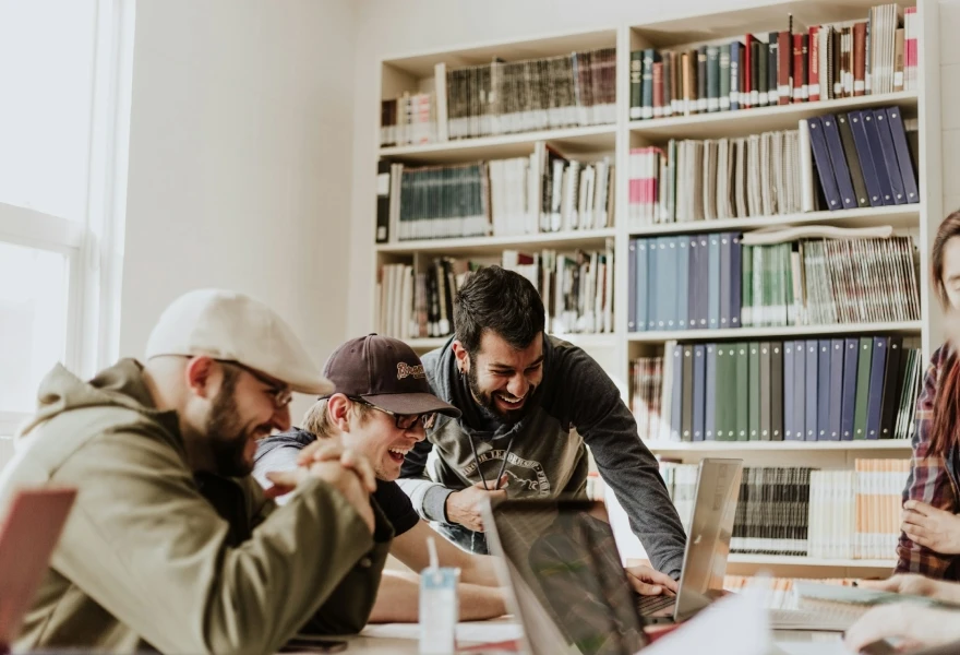 Team celebrating around a computer