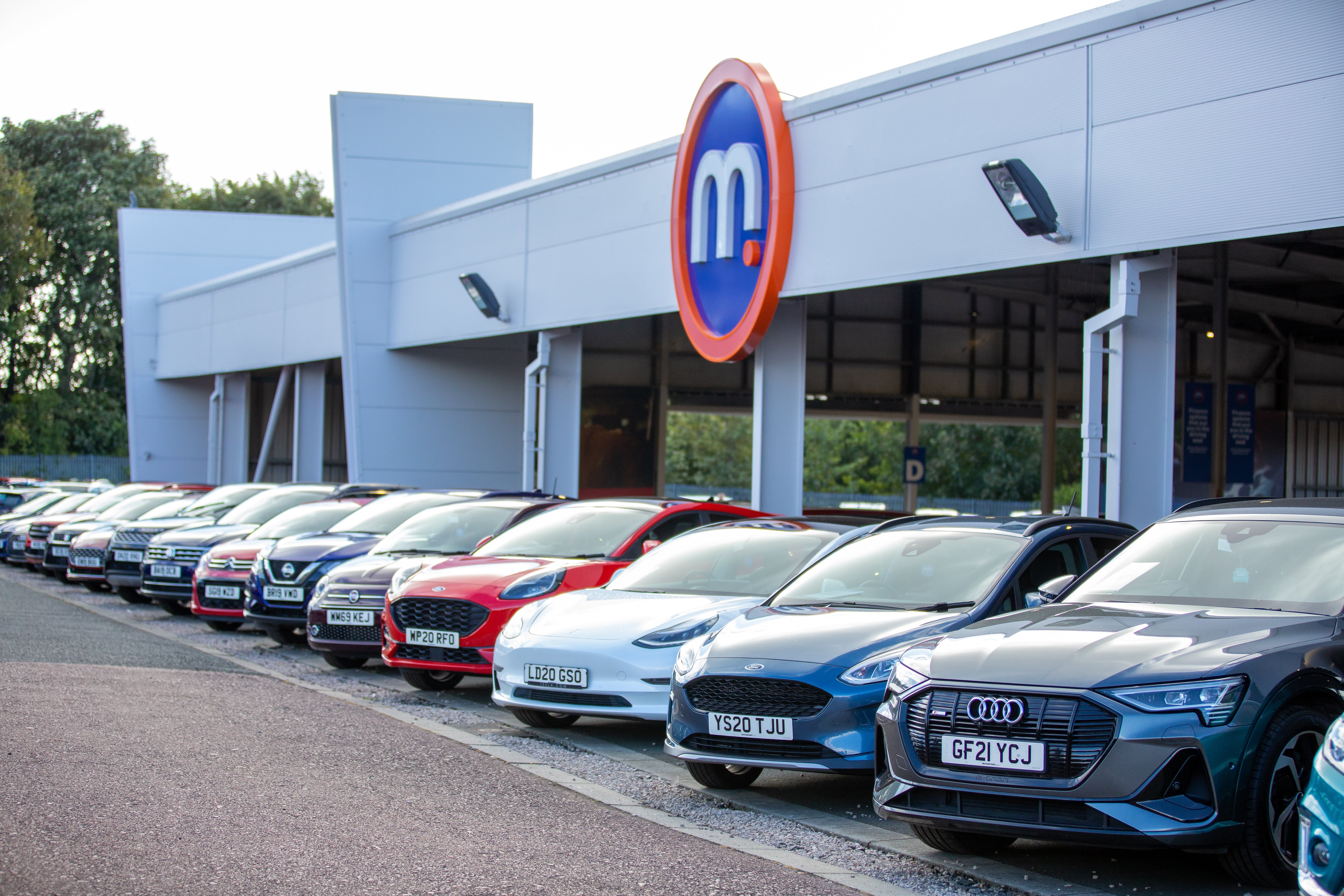 Used cars in front of a Motorpoint dealership.