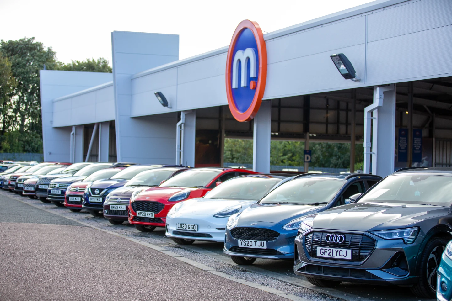 Used cars in front of a Motorpoint dealership.