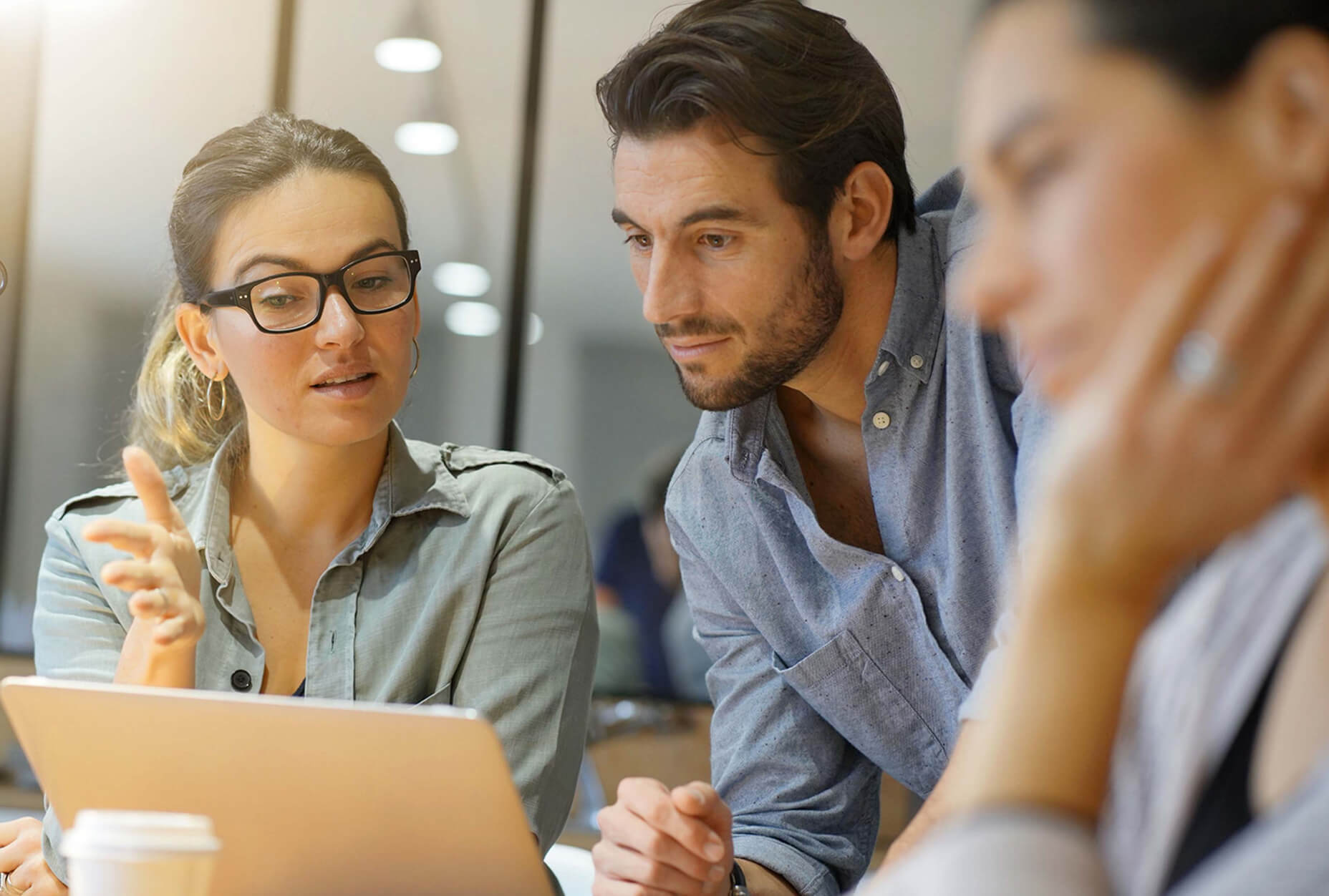 A group of people looking at a laptop