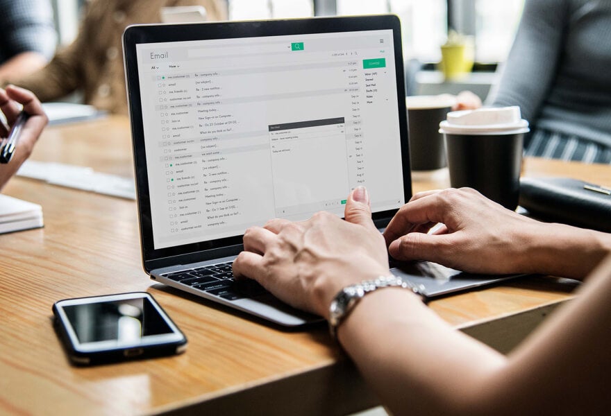 A person typing on a laptop