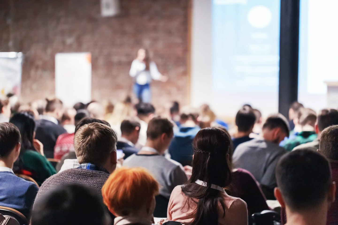 A woman standing in front of a crowd of people