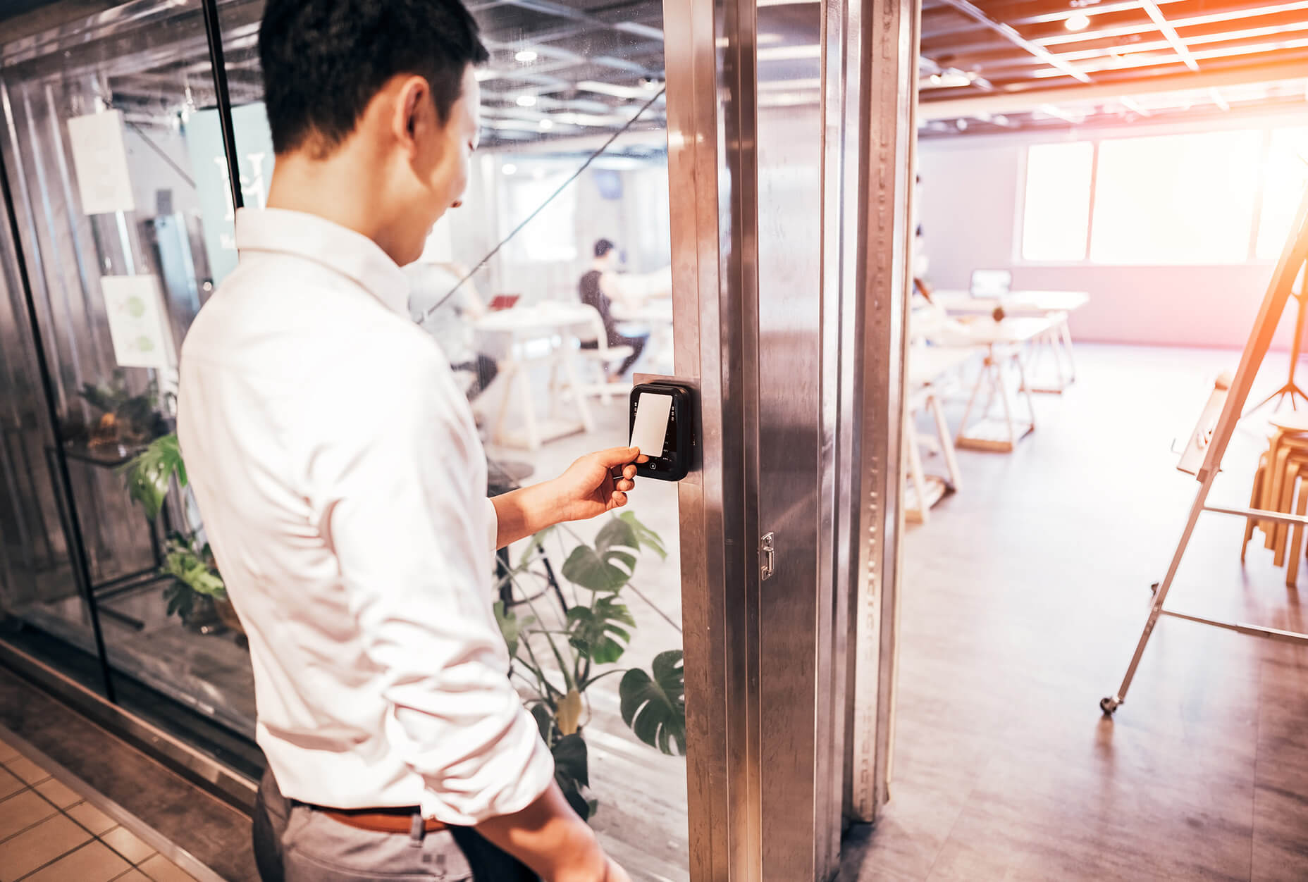 A man using a keypad to open a door