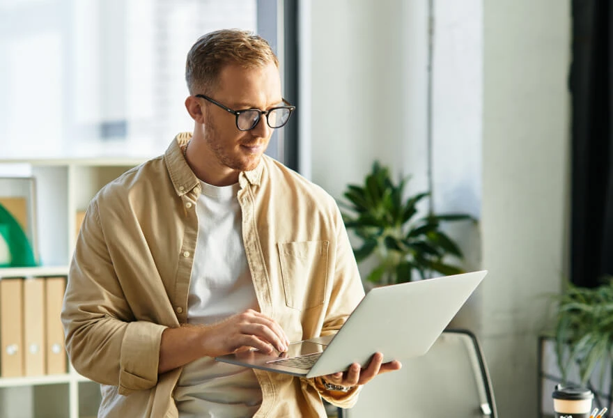 A man holding a laptop