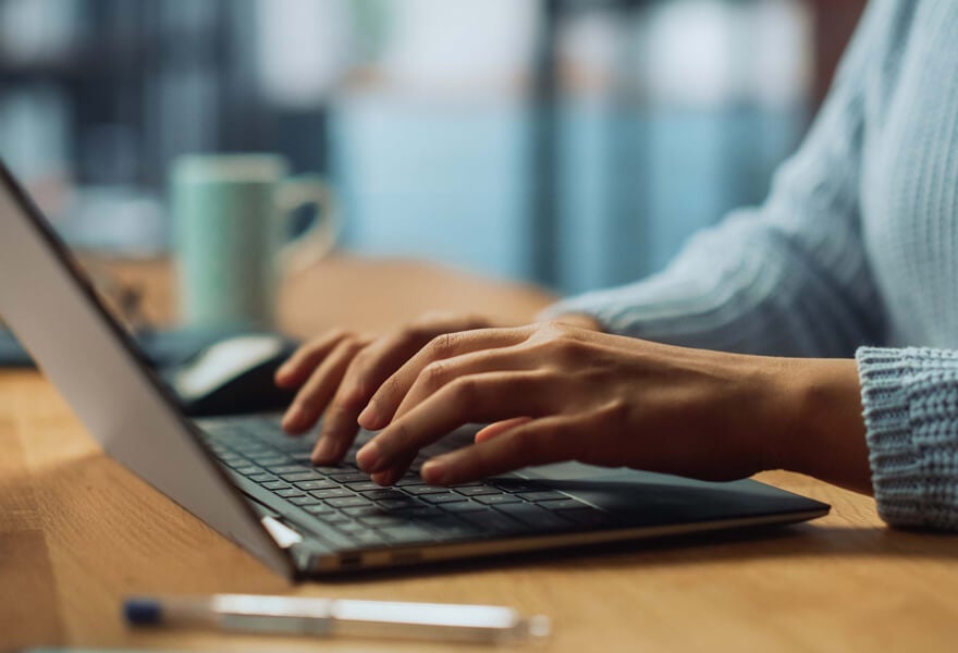 A person typing on a laptop