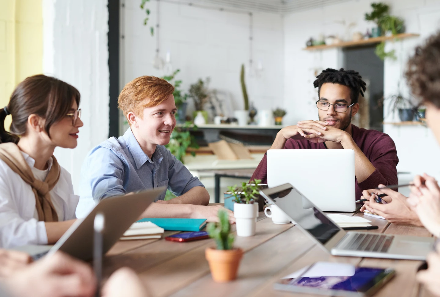 Four young people working on content