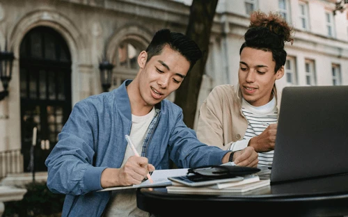 Two young marketers researching content
