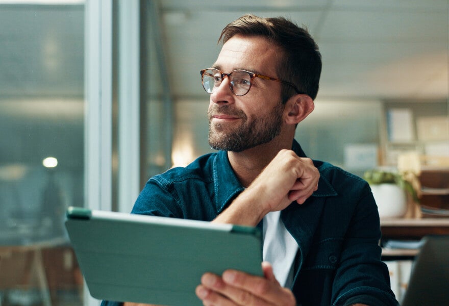 A man thinking, smiling slightly and looking to the left