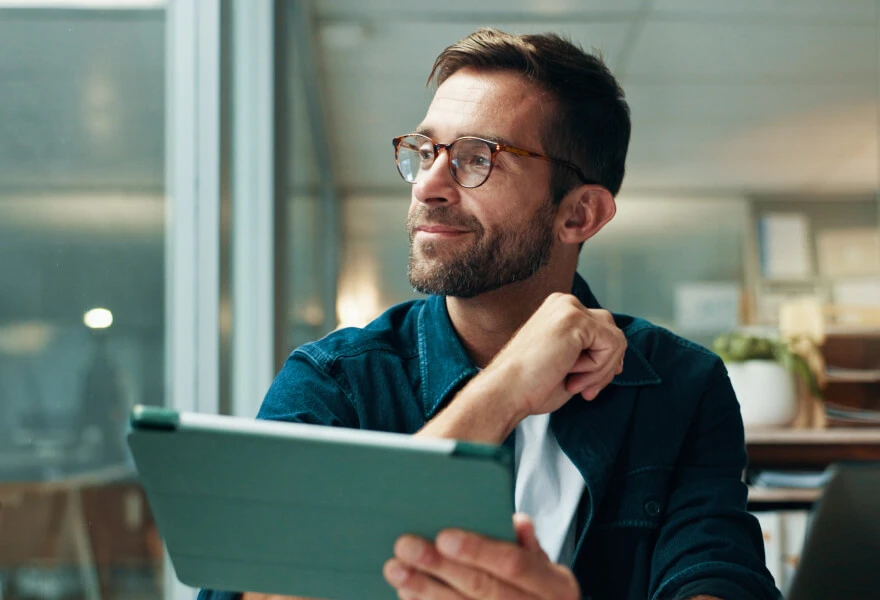 A man thinking, smiling slightly and looking to the left