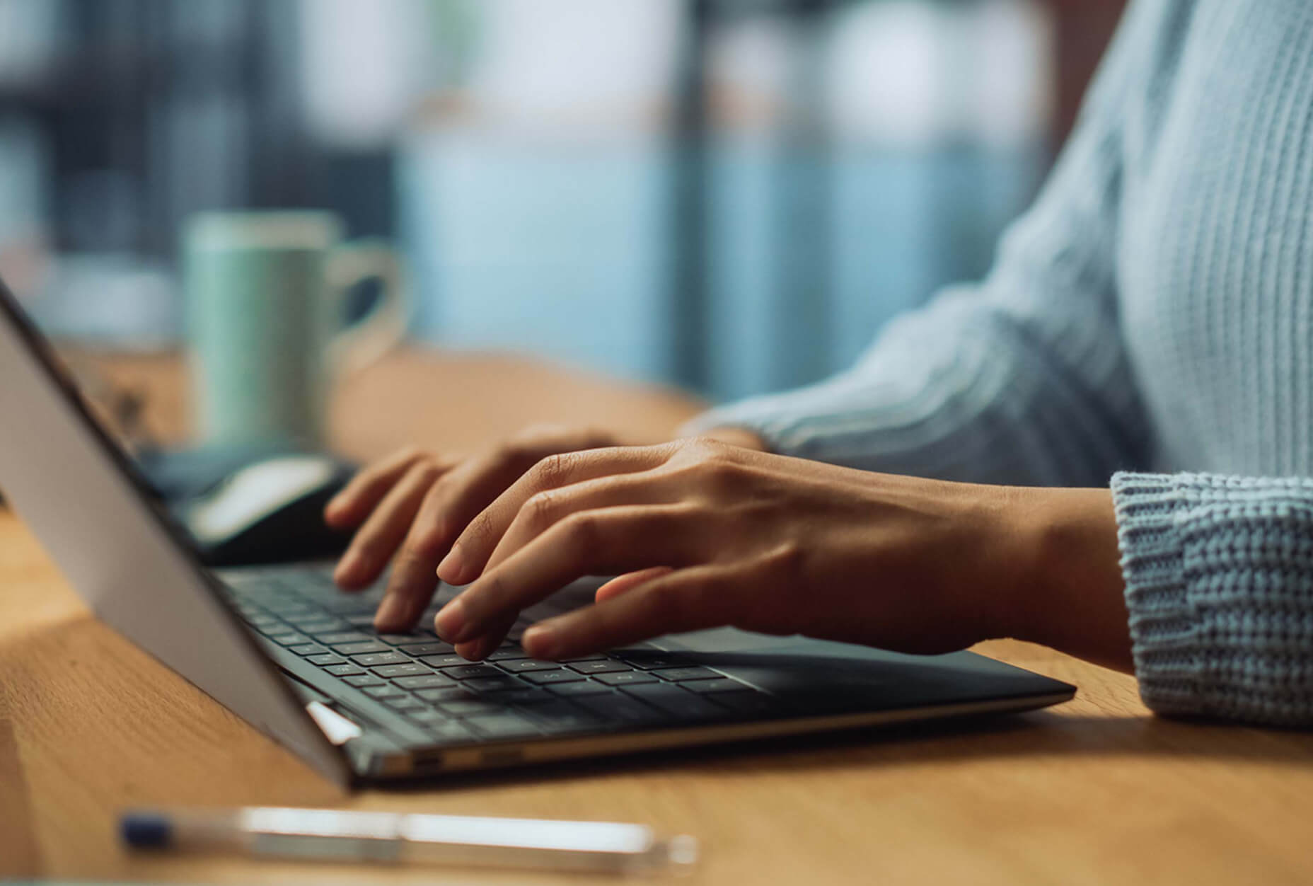 A person typing on a laptop