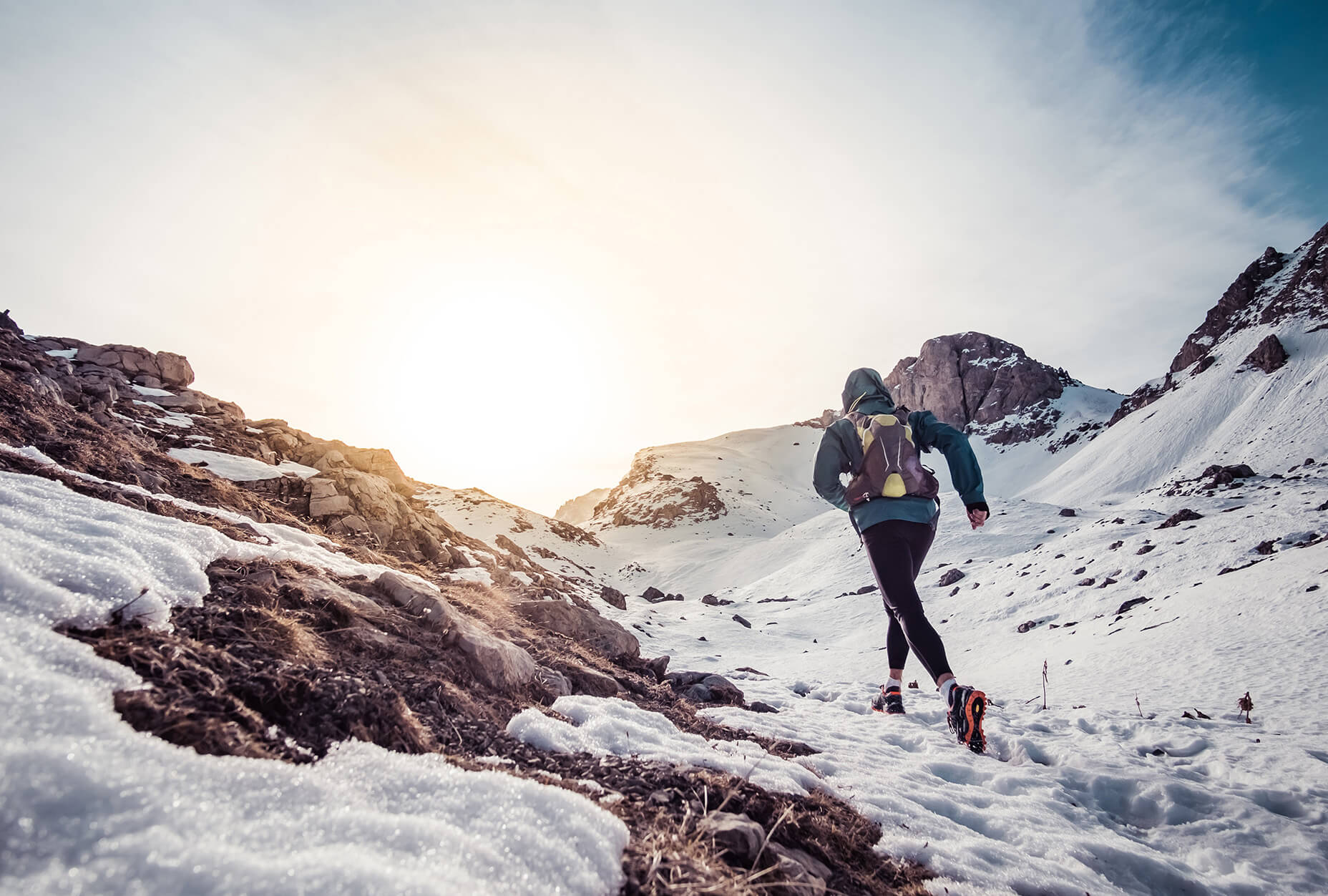 Man running on the snow on a mountain
