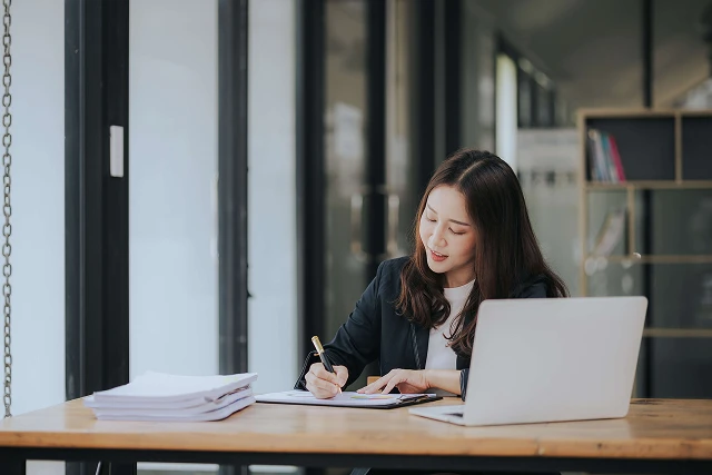 A financial services expert working on printed and digital content