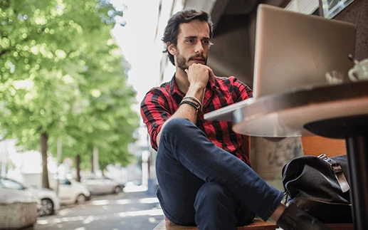 Man creating PDFs out of headless content in a coffee shop