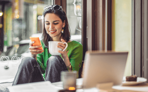 Woman checking her content on mobile in a coffee shop